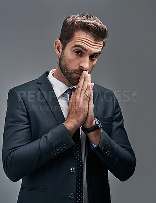 Buy stock photo Studio portrait of a handsome young businessman posing against a grey background