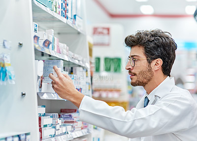 Buy stock photo Pharmacist, reading medicine and man in pharmacy while working in store for retail career. Male person in pharmaceutical or medical industry for service, healthcare and inventory check on shelf