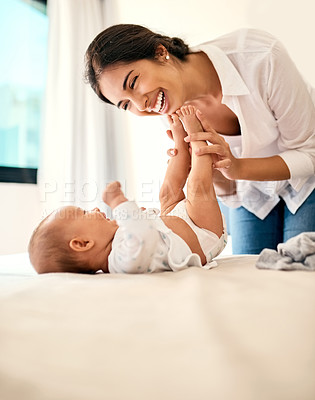 Buy stock photo Happy, love and a mama with her baby in the bedroom of their home together for playful bonding. Family, children and a young mother spending time with her newborn infant on the bed for fun or joy