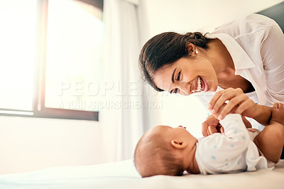 Buy stock photo Happy, love and a mother with her baby in the bedroom of their home together for playful bonding. Family, children and a young mama spending time with her newborn infant on the bed for fun or joy