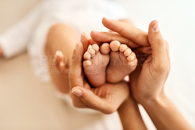 Buy stock photo Cropped shot of a mother gently holding her baby’s feet