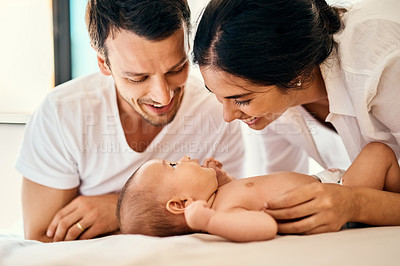 Buy stock photo Shot of a happy mother and father bonding with their baby boy at home