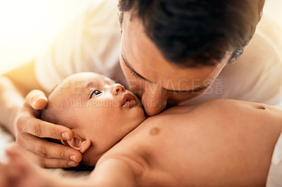 Buy stock photo Shot of a father bonding with his baby boy at home