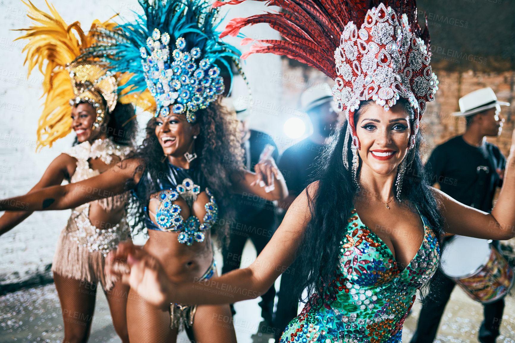 Buy stock photo Cropped shot of beautiful samba dancers performing in a carnival with their band
