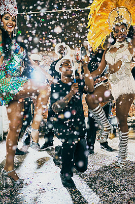Buy stock photo Shot of beautiful samba dancers performing in a carnival with their band