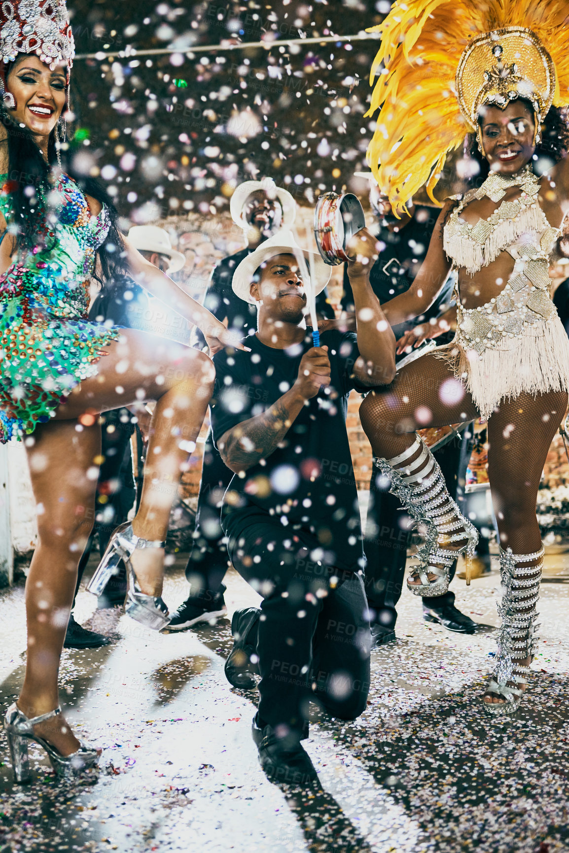 Buy stock photo Shot of beautiful samba dancers performing in a carnival with their band