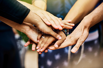 Buy stock photo Shot of a group of unrecognizable people's hands forming a huddle together outside during the day