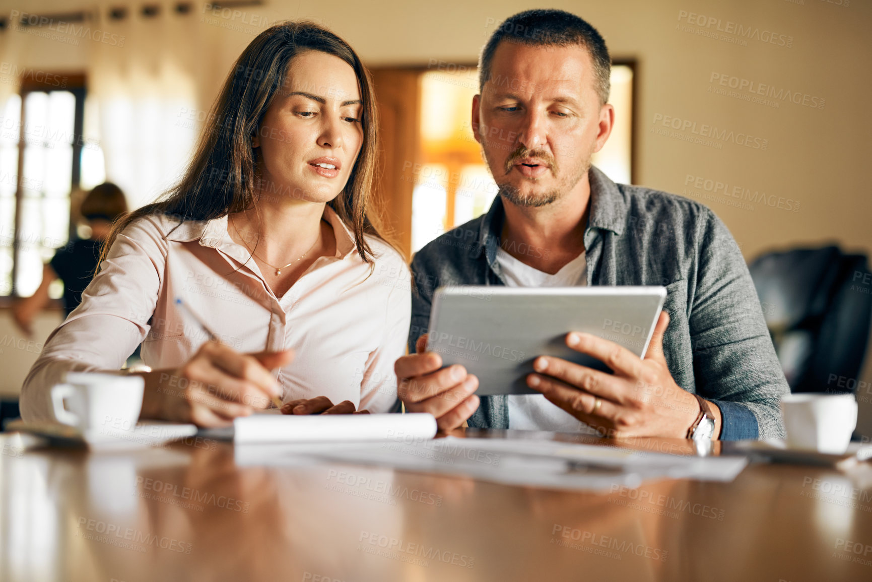 Buy stock photo Cropped shot of a married couple planning their financial budget at home