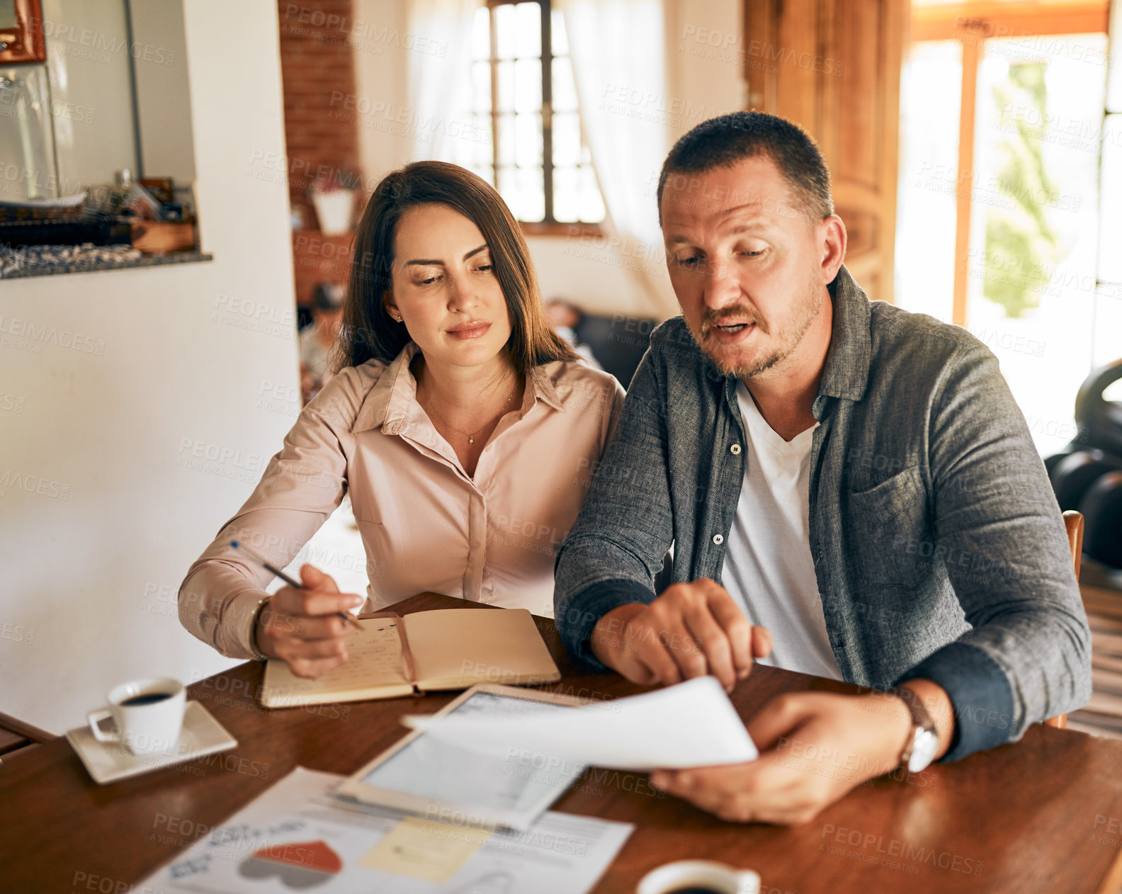 Buy stock photo Cropped shot of a married couple planning their financial budget at home