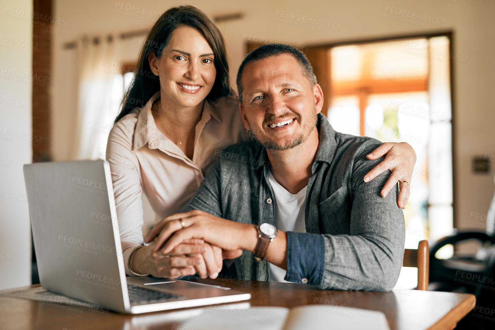 Buy stock photo Couple, portrait and hug with laptop in home for planning financial budget, mortgage investment and loan application. People, happy and embrace at dining table with technology for accounts payment