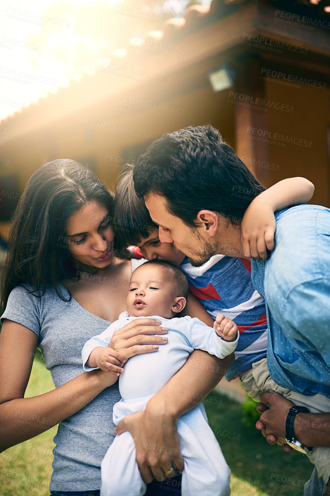 Buy stock photo Cropped shot of a happy young family of four outside with their house in the background