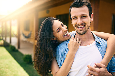Buy stock photo Cropped portrait of an affectionate young couple standing outside with their house in the background