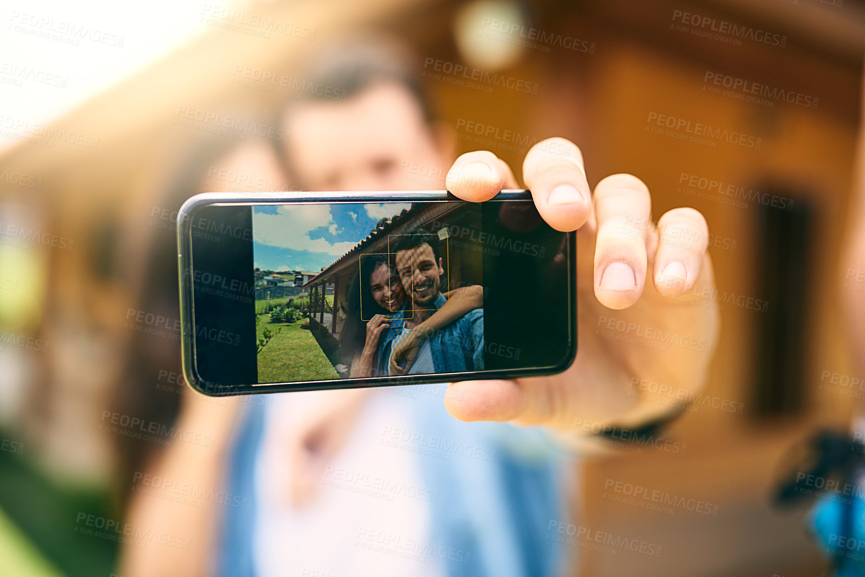 Buy stock photo Happy couple, hug and phone screen for selfie, photo or profile picture together in relationship outdoors. Hand of man holding smartphone with woman hugging for love, memory or capture outside home