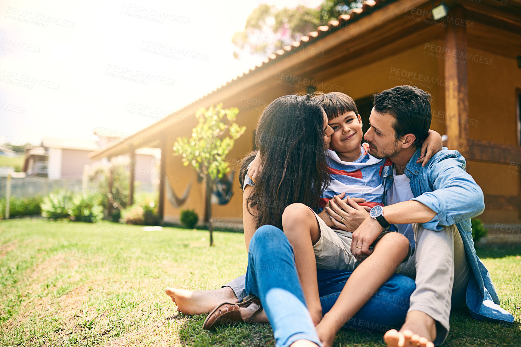 Buy stock photo Happy family, portrait and parents kiss kid at garden for love, care or bonding together on lawn to relax. Smile, mother and father with child outdoor by house for support, connection or relationship