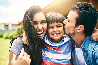 Buy stock photo Cropped portrait of a happy young family of three sitting outside in their backyard