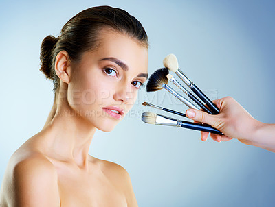 Buy stock photo Portrait, woman and confident with makeup brushes for cosmetology, beauty or glow. Female person, cosmetic tools and skincare for makeover, dermatology and wellness with beautician on blue background