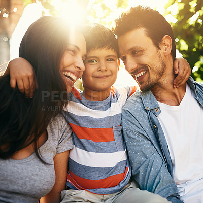 Buy stock photo Portrait of an adorable little boy bonding with his parents outdoors