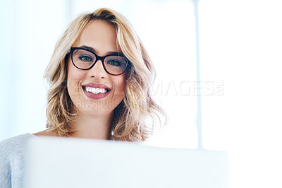 Buy stock photo Portrait of an attractive young businesswoman working on a laptop in an office