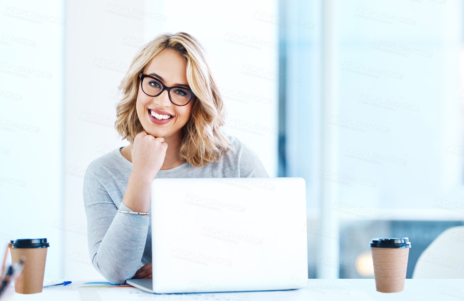 Buy stock photo Portrait of an attractive young businesswoman working on a laptop in an office