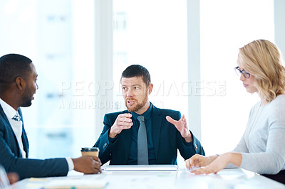 Buy stock photo Shot of a group of businesspeople having a meeting in an office