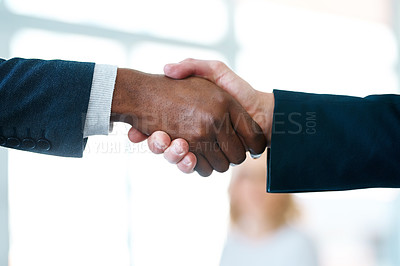 Buy stock photo Closeup shot of two unrecognizable businessmen shaking hands in an office