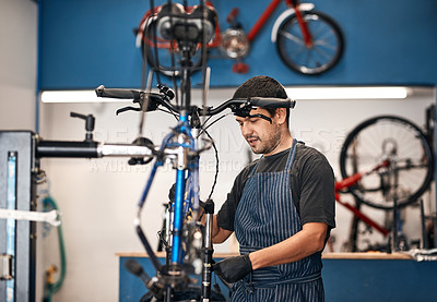 Buy stock photo Shot of a man working in a bicycle repair shop