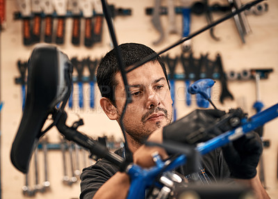 Buy stock photo Bike repair, face and maintenance with man in workshop for frame building or professional engineering. Assessment, bicycle and transport tools with mechanic or technician in startup for restoration