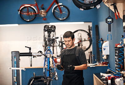 Buy stock photo Bike repair, cable maintenance and man in workshop for frame building or professional engineering. Assessment, bicycle and transportation with mechanic or technician in startup for restoration