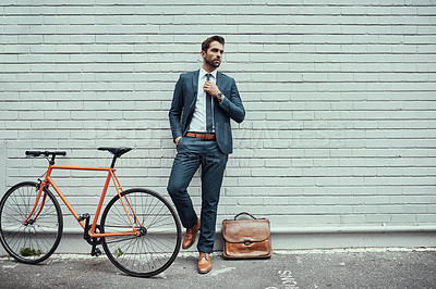 Buy stock photo Business man, street and suit with bicycle by wall, commute or sustainable travel in city. Person, style and bike for eco friendly transportation on urban sidewalk, road and mock up space in Milan