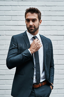 Buy stock photo Portrait of a handsome young businessman posing against a white wall outdoors