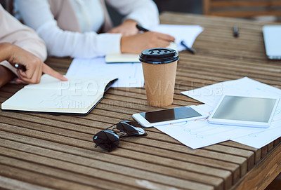 Buy stock photo Cropped shot of a group of unrecognizable businesspeople sitting in the boardroom during a meeting