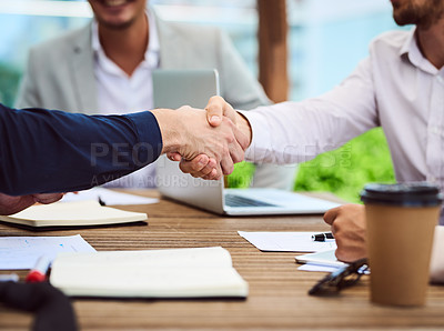 Buy stock photo Closeup shot of two unrecognizable businesspeople shaking hands during a meeting in the boardroom