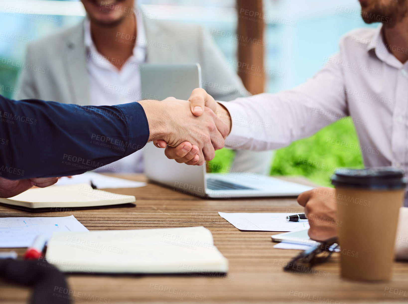Buy stock photo Closeup shot of two unrecognizable businesspeople shaking hands during a meeting in the boardroom