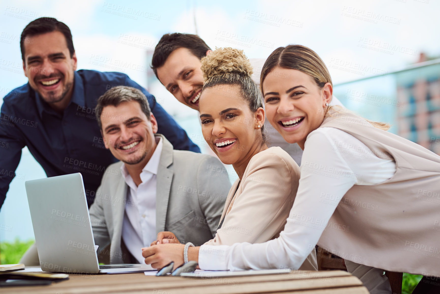 Buy stock photo Cropped portrait of a group of businesspeople gathered around a laptop during a meeting in the boardroom