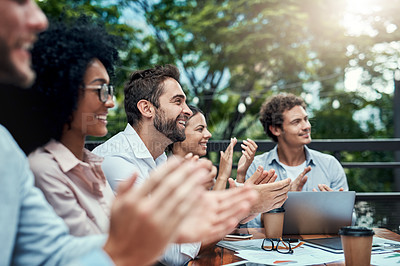 Buy stock photo Shot of a group of colleagues applauding during a meeting at a cafe
