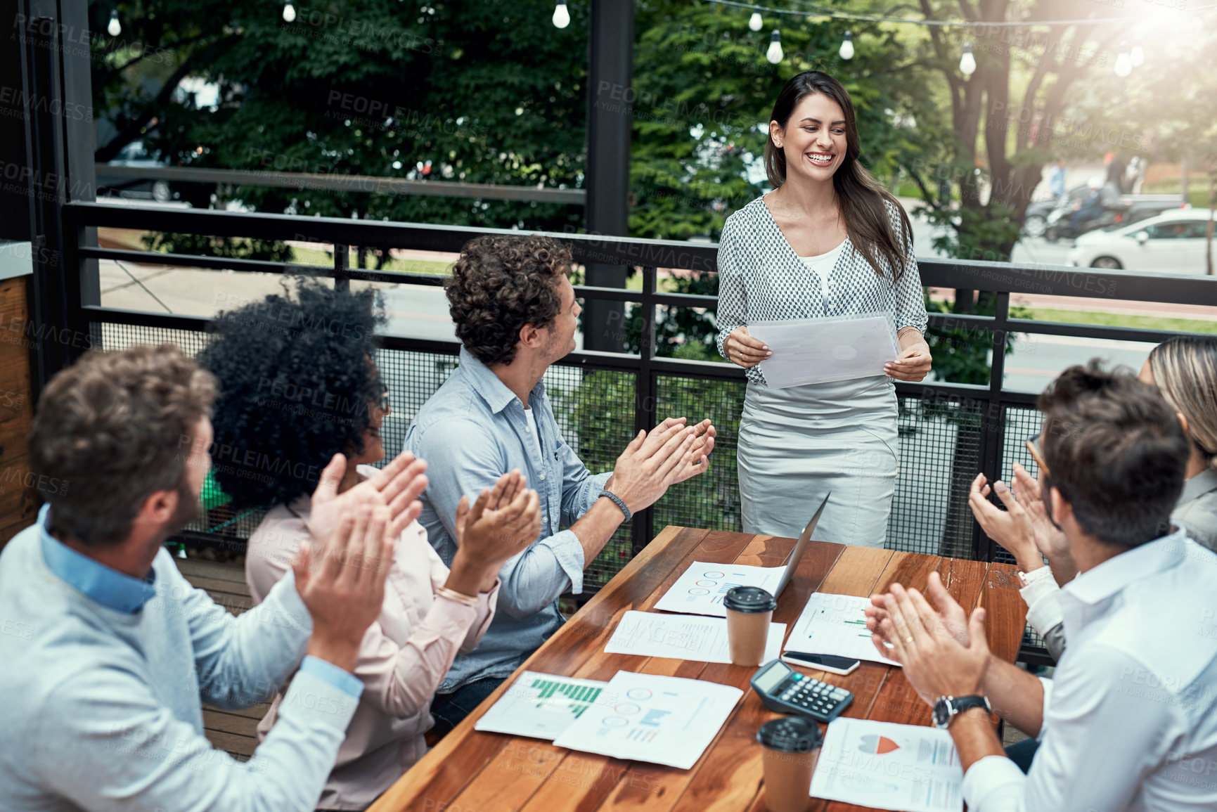 Buy stock photo Shot of a group of colleagues applauding during a meeting at a cafe