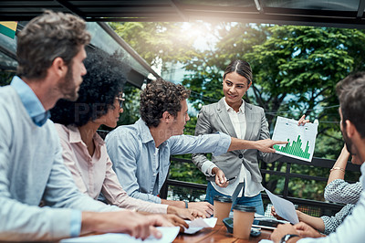 Buy stock photo Shot of a group of colleagues having a meeting at a cafe