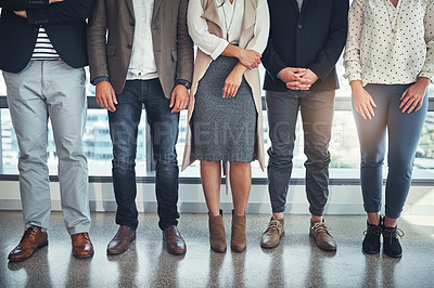 Buy stock photo Shot of a group of unrecognizable businesspeople standing in line in an office