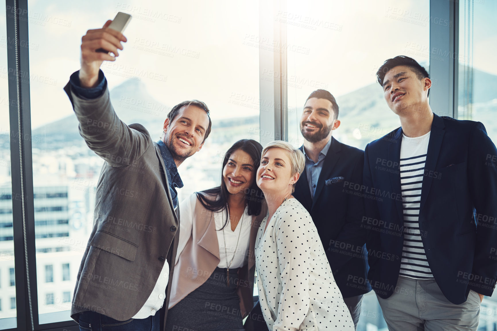 Buy stock photo Shot of a group of businesspeople taking a selfie together in an office