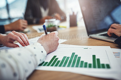 Buy stock photo Closeup shot of unrecognizable businesspeople analyzing graphs in an office