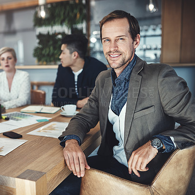 Buy stock photo Portrait of a mature businessman sitting in a meeting in an office