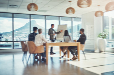 Buy stock photo Blurred shot of a group of businesspeople having a meeting in an office