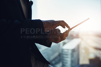 Buy stock photo Closeup shot of an unrecognizable businessman using a digital tablet in an office