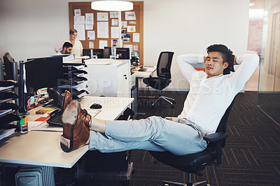 Buy stock photo Shot of a businessman taking a break in the office