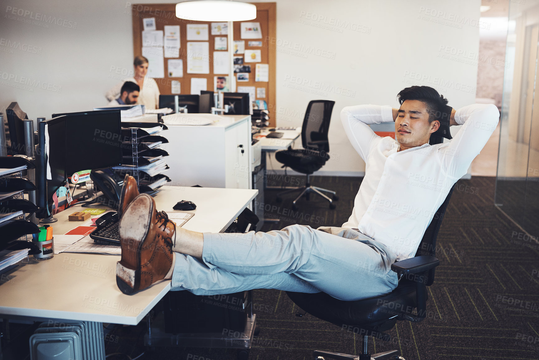 Buy stock photo Shot of a businessman taking a break in the office