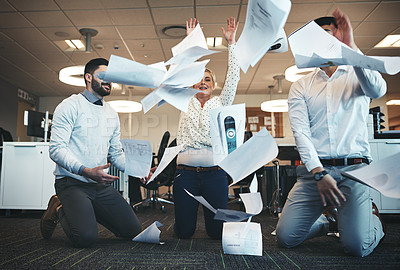 Buy stock photo Shot of businesspeople throwing paperwork in the air in the office