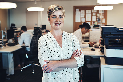 Buy stock photo Portrait of a businesswoman in the office while her colleagues are working in the background