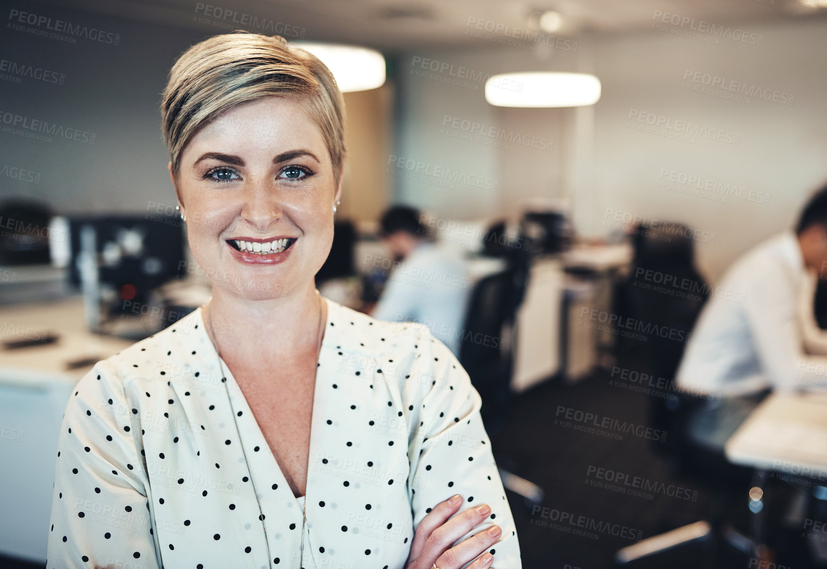 Buy stock photo Portrait of a businesswoman in the office while her colleagues are working in the background