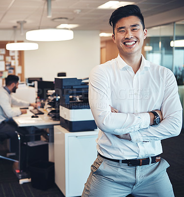 Buy stock photo Portrait of a businessman in the office while his colleagues are working in the background