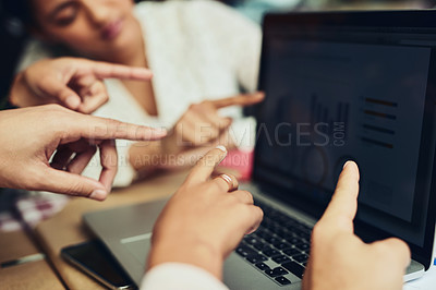 Buy stock photo Cropped shot of unrecognizable designers pointing at information on a laptop screen at a coffee shop